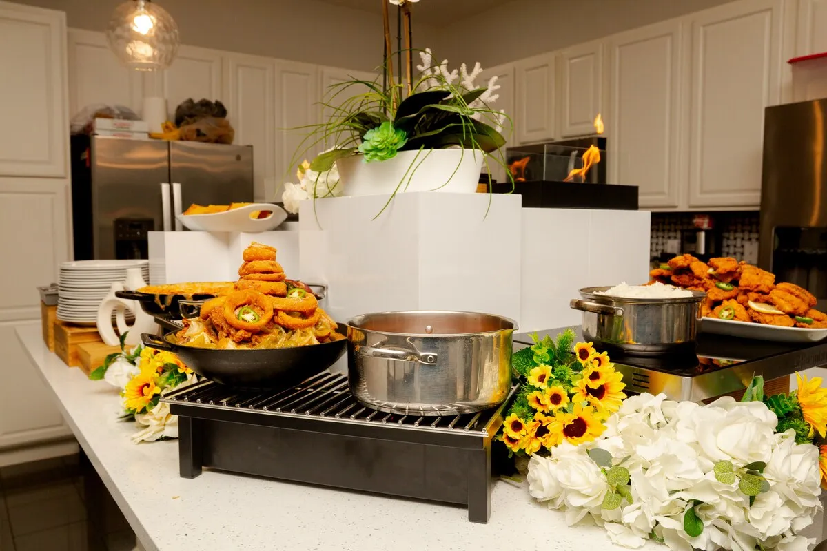 A spread of Tony's dishes with sunflowers and white roses