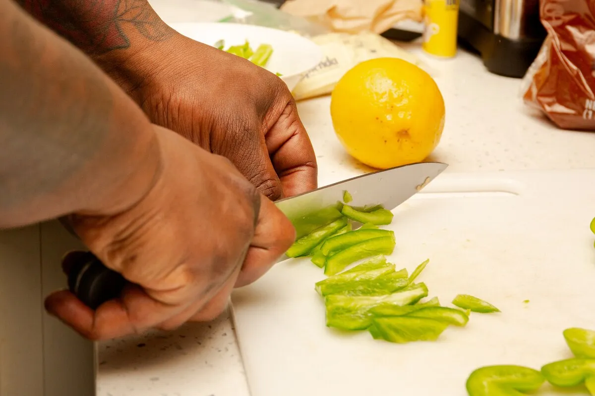 Tony chopping green peppers