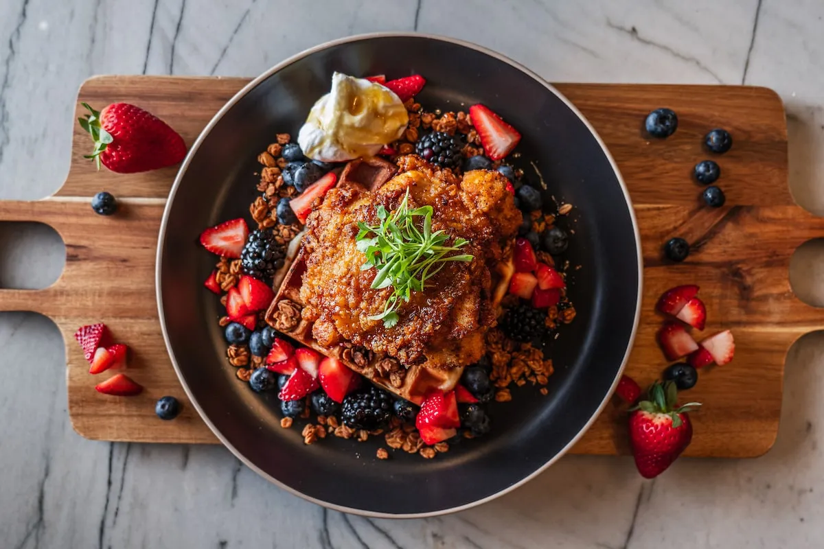 French toast with fresh berries on a wooden board