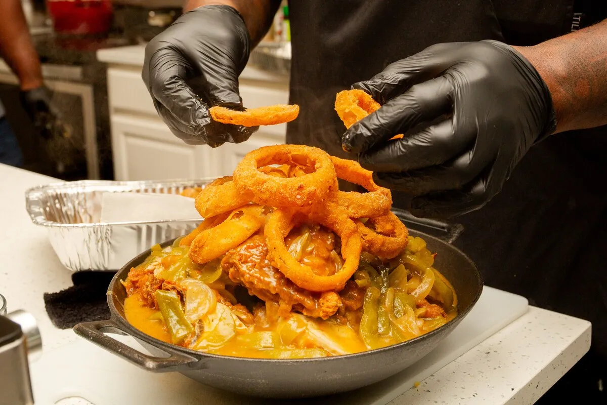 Onion rings stacked on a smothered dish
