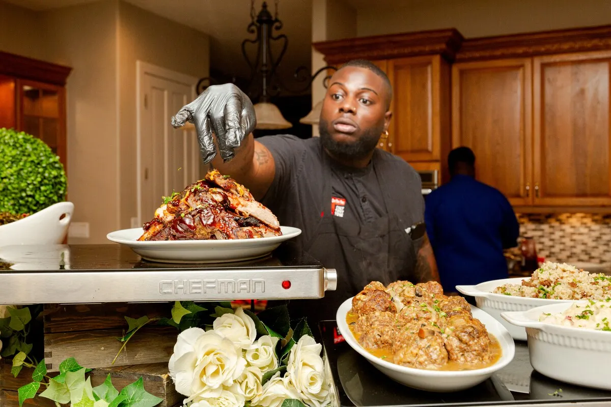 Tony plating a dish at a buffet
