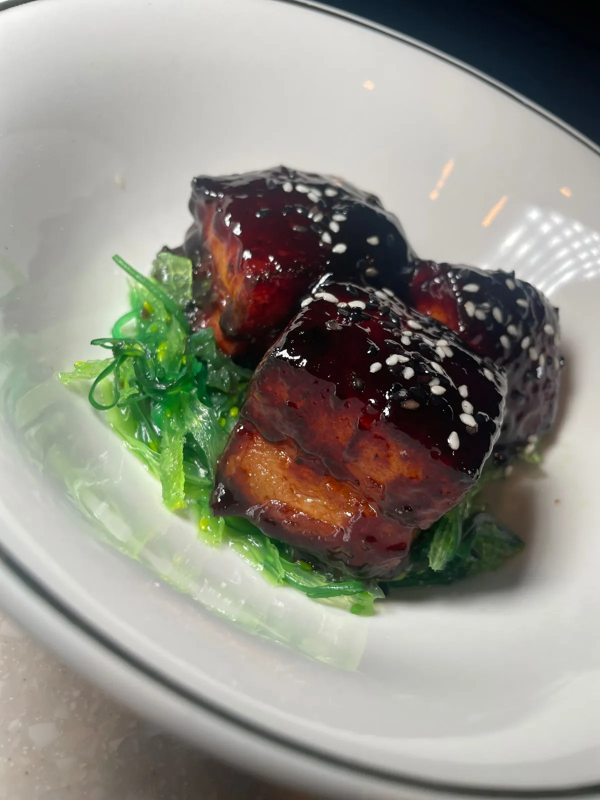 Glazed pork belly with greens